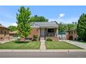 Charming brick home with a well-kept lawn and inviting curb appeal at 2430 S Ogden St, Denver, CO 80210