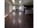 Living room has vaulted ceiling with skylights, wood floors and a brick fireplace at 16136 E Exposition Dr, Aurora, CO 80017
