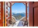 Picturesque balcony view framed by wood beams, offering a serene escape with seating and mountain vistas at 351 Kimmes Ln, Breckenridge, CO 80424