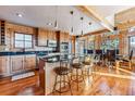 Charming kitchen with modern stainless steel appliances, granite countertops, a breakfast bar, and hardwood floors at 351 Kimmes Ln, Breckenridge, CO 80424