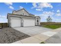 Charming two-story home boasting a spacious driveway, two-car garage, and well-maintained exterior at 5700 Ranch St, Mead, CO 80504