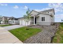Inviting two-story home with a two-car garage, manicured lawn, and charming landscaping at 5700 Ranch St, Mead, CO 80504