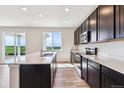 Modern kitchen with stainless steel appliances, sleek countertops, and a scenic view at 5700 Ranch St, Mead, CO 80504