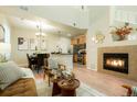 Inviting living room is adjacent to the kitchen and dining area, and has a cozy fireplace at 7777 E 23Rd Ave # 401, Denver, CO 80238