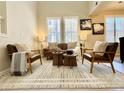 Comfortable living room boasts lots of natural light, neutral paint, and plush chairs and sofa at 7777 E 23Rd Ave # 401, Denver, CO 80238