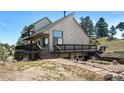 Hillside home featuring an expansive deck with stone walkway and natural surroundings at 251 Ridgeview Ln, Boulder, CO 80302