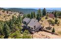 Beautiful mountain home with expansive deck and a view surrounded by lush trees at 251 Ridgeview Ln, Boulder, CO 80302