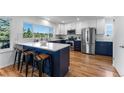 Modern kitchen with white cabinets, dark blue island, stainless appliances and mountain view at 251 Ridgeview Ln, Boulder, CO 80302