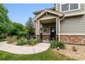 Townhome's front entrance with a covered porch and walkway at 1879 S Buchanan Cir, Aurora, CO 80018