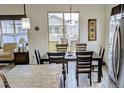 Cozy dining area with a large window, modern lighting, and view of the backyard patio at 22345 E Bailey Pl, Aurora, CO 80016