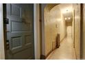 Building hallway with vintage tile floor and exposed plaster walls at 1441 N Pennsylvania St # 3, Denver, CO 80203