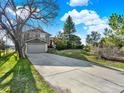 Two-story home featuring a spacious driveway, a two-car garage, and established landscaping at 12798 Tomahawk Rd, Parker, CO 80138