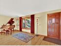 Well-lit living room with hardwood floors, a large window, and a decorative rug at 12798 Tomahawk Rd, Parker, CO 80138