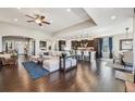 Expansive living space with a kitchen island, dining area, and comfortable seating, perfect for entertaining at 27423 E Euclid Dr, Aurora, CO 80016
