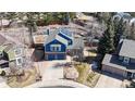 Overhead view of a lovely two-story home with solar panels, landscaped yard, mature trees and driveway at 7464 Shoreham Pl, Castle Pines, CO 80108