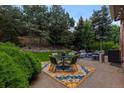 Outdoor patio area with comfortable seating, a dining table, manicured bushes, and a heater at 6132 S Boston Cir, Greenwood Village, CO 80111