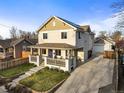 Charming two-story home featuring a welcoming front porch and well-maintained landscaping at 4942 Grove St, Denver, CO 80221