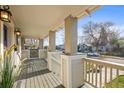 Inviting covered porch with classic columns, offering a relaxing outdoor space at 4942 Grove St, Denver, CO 80221