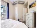 Bright bedroom featuring a large window with blinds, neutral walls, and modern furnishings at 1441 Central # 305, Denver, CO 80211
