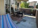 Cozy outdoor patio with dining set and hammock, offering a relaxing space with a private view at 1441 Central # 305, Denver, CO 80211
