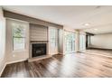 Spacious living room featuring a fireplace, wood floors, and a sliding glass door at 8717 Carr Loop, Arvada, CO 80005