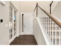 Bright entryway with hardwood floors, staircase, and french doors at 10993 Ledges Rd, Parker, CO 80134