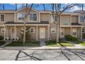 Charming townhouse showcasing a well-maintained front yard and covered entrance at 1818 S Quebec Way # 3-4, Denver, CO 80231