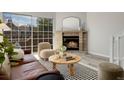 Cozy living room boasting a brick fireplace and sliding glass doors to the balcony at 1818 S Quebec Way # 3-4, Denver, CO 80231