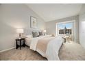 Bright main bedroom with vaulted ceiling, large window, and neutral decor at 1818 S Quebec Way # 3-4, Denver, CO 80231