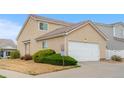The exterior of the house has a two car garage with a beautifully paved driveway and manicured landscaping at 20835 E 47Th Ave, Denver, CO 80249