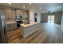 Open concept kitchen and living area with hardwood floors and modern finishes at 9444 Yampa St, Commerce City, CO 80022