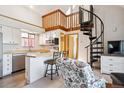 The kitchen has stainless appliances and there is a spiral staircase that provides access to an upper level at 5250 S Huron Way # 5-308, Littleton, CO 80120