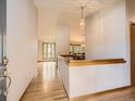 Bright foyer featuring hardwood floors, decorative lighting, and a view into other rooms at 9670 W 69Th Ave, Arvada, CO 80004