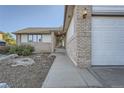A welcoming entryway with a brick facade and a pathway leading to the front door at 9670 W 69Th Ave, Arvada, CO 80004