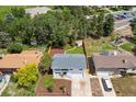 Aerial view of landscaped backyard featuring shed, wood fence, mature trees, and pristine lawn at 13051 W Jewell Cir, Lakewood, CO 80228