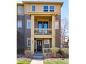 Inviting townhome entrance featuring a private balcony above and neat landscaping at 658 Casper Dr, Lafayette, CO 80026