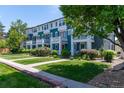 Attractive row of townhomes featuring blue and white exteriors with well-maintained landscaping and lawns at 658 Casper Dr, Lafayette, CO 80026