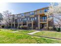 View of lovely townhomes with manicured lawns and walkways under a clear sky at 658 Casper Dr, Lafayette, CO 80026