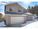 Charming two-story home with neutral siding, attached garage, and inviting front entrance near a treeline at 2120 Gross Dam Rd, Golden, CO 80403