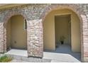 Covered entryway with elegant stone archways leading to a welcoming front door at 3437 Rosato Dr # C, Highlands Ranch, CO 80126