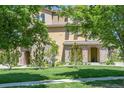 Inviting view of a multi-story home with stone accents and lush greenery at 3437 Rosato Dr # C, Highlands Ranch, CO 80126