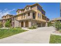 Charming multi-story home featuring stone accents, a three-car garage, and a well-maintained lawn at 3437 Rosato Dr # C, Highlands Ranch, CO 80126
