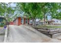 Inviting home exterior with a long driveway, mature trees, and a well-maintained yard at 4841 Alcott St, Denver, CO 80221