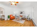 Bright living room featuring hardwood floors, neutral decor, and comfortable seating arrangement at 4841 Alcott St, Denver, CO 80221