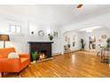 Spacious living room with hardwood floors, black brick fireplace, and ample natural light at 4841 Alcott St, Denver, CO 80221