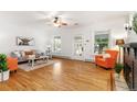 Well-lit living room showcasing hardwood floors, fireplace, and large windows at 4841 Alcott St, Denver, CO 80221