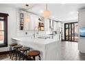 Bright, remodeled kitchen featuring white cabinetry, quartz countertops, hexagon tile floors and stainless steel appliances for modern living at 438 S Emerson St, Denver, CO 80209