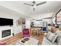 Open-concept living space with a fireplace, kitchen island, and stylish furnishings at 6162 W 28Th Ct, Edgewater, CO 80214