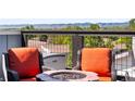 Inviting rooftop with comfortable seating around a modern fire pit and stunning mountain views at 6162 W 28Th Ct, Edgewater, CO 80214