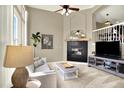 Comfortable living room with tall ceilings, black fireplace, neutral decor and carpeted floors at 3720 Pecos Trl, Castle Rock, CO 80109